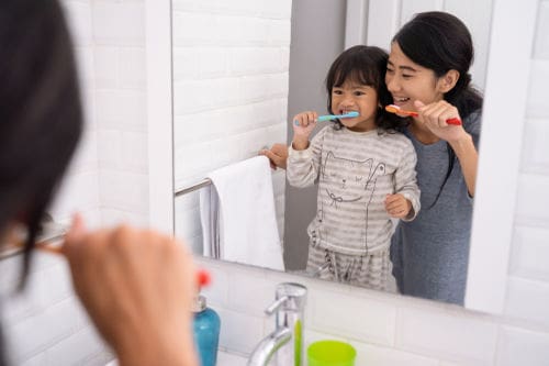 Best Dentist Manassas | Mom brushing child teeth