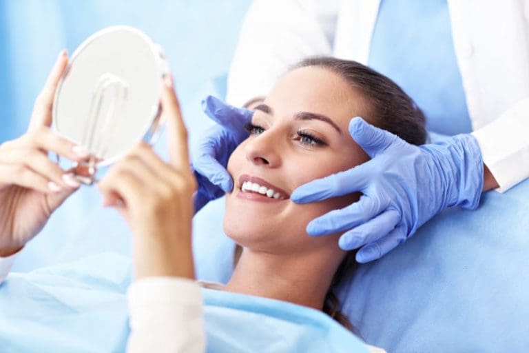 Manassas Emergency Dentist | Dental Patient looking at mirror.